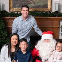 A family of four sitting with Santa.